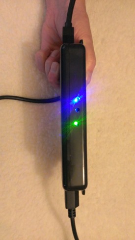 The prototype router box that supplies power and connects the Kinect for Windows v2 sensor to the computer through USB3.0. The very bright LEDs indicate that the sensor is powered and connected. Photo: Jim Galasyn